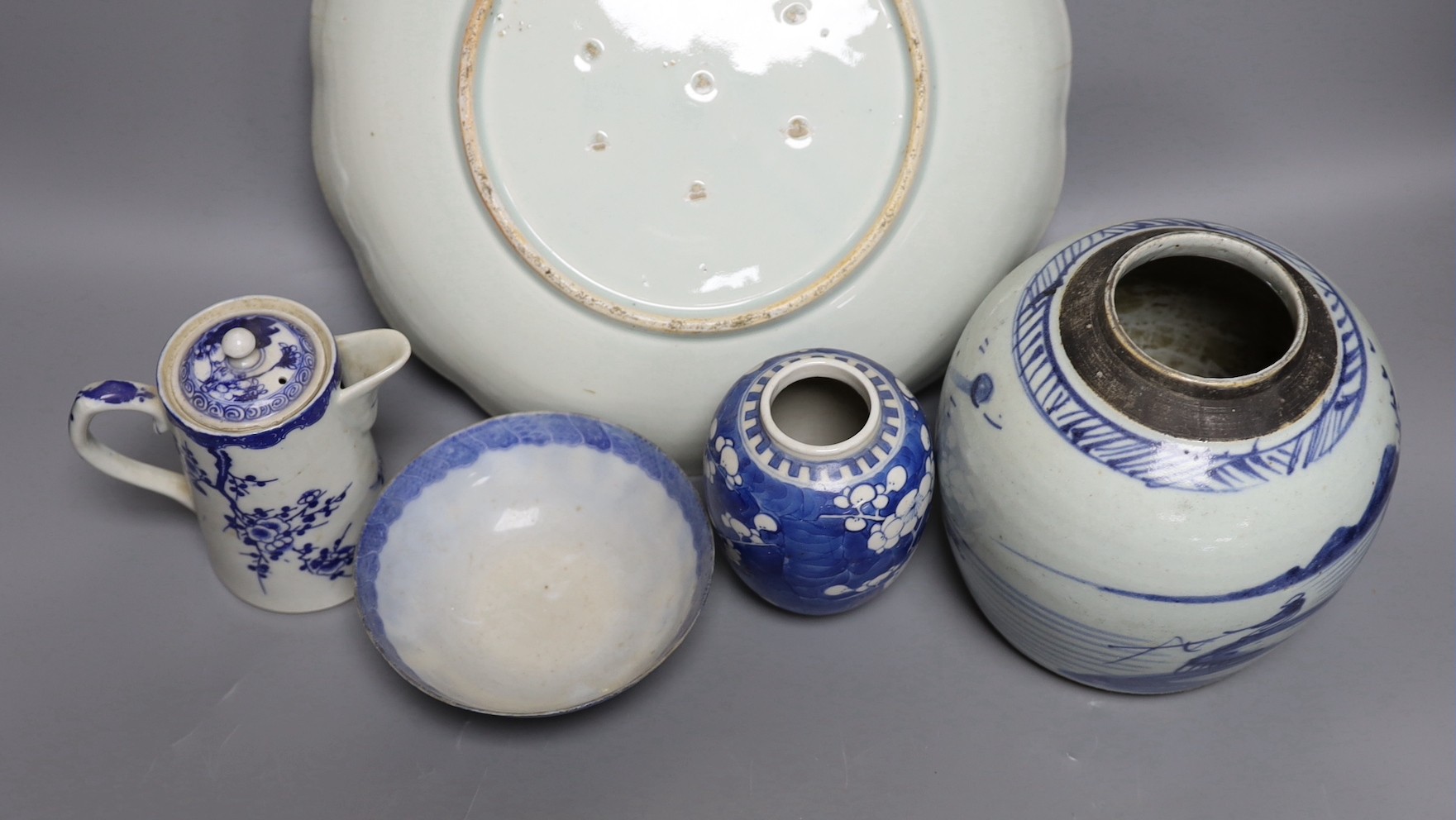 A Japanese Edo period blue and white dish, a Chinese Prunus blossom jar, late 19th century, a provincial blue and white jar and other items, dish 31 cms diameter